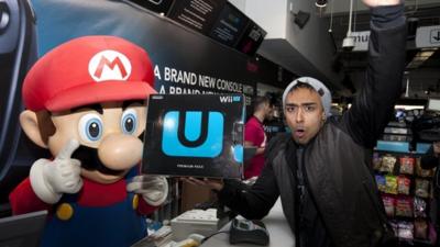 Izzy Rahman, the first person to buy a new Wii U console from the HMV store on London's Oxford Street