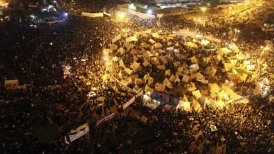 Tents lit up at night in Tahrir Square