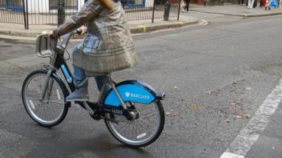 Woman riding a Barclays Cycle Hire bicycle