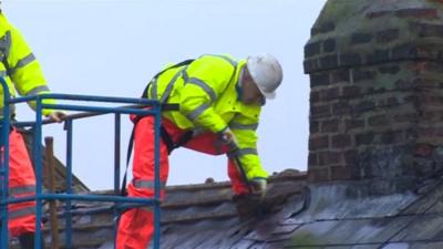 Workers begin dismantling the houses