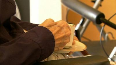 Elderly person drinking tea