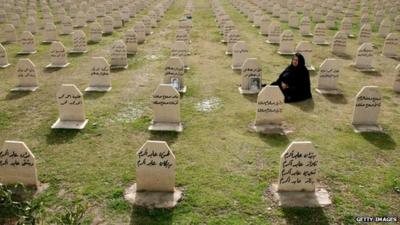 A woman visits the graves of relatives who were killed in a gas attack by former Iraqi president Saddam Hussein in 1988.