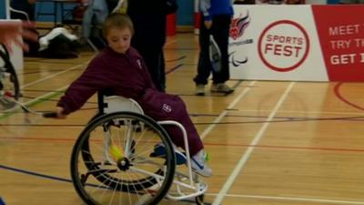 Young person tries out wheelchair tennis