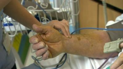 Patient having blood pressure checked in a hospital