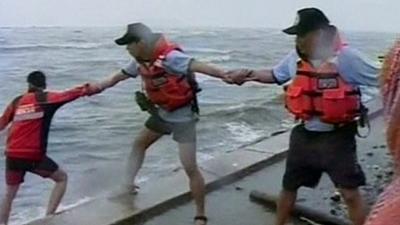 Rescue workers link arms