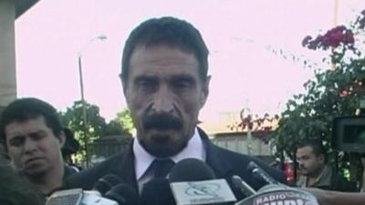 John McAfee talking to journalists