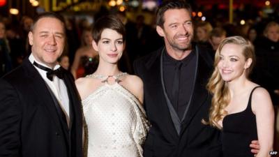 Russell Crowe (L) Anne Hathaway (2-L) Hugh Jackman (2-R) and Amanda Seyfried (R) pose for photographers on the red carpet ahead of the world premiere of Les Miserables