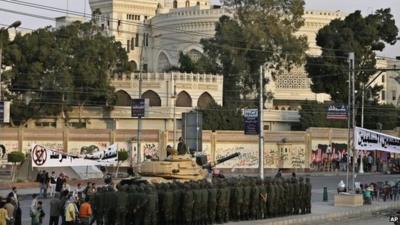 Egyptian army soldiers stand guard in front of the presidential palace in Cairo on 9 December.