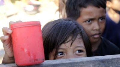 Children wait for porridge