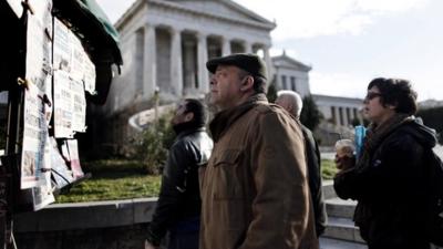 Greek residents reading newspapers