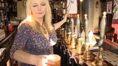 Woman pulling a pint