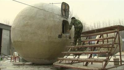 Liu Qiyuan inspects one of his pods