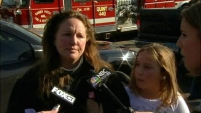 A mother and child being interviewed outside the school.