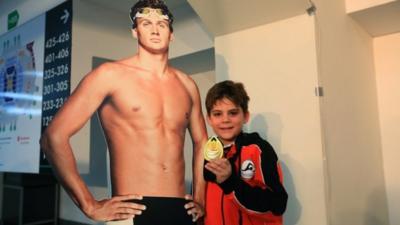 Ryan Lochte fan with his gold medal