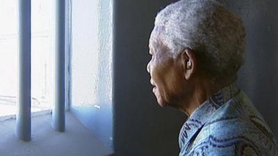 Mandela looks through prison bars