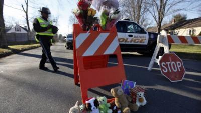 A police roadblock turned into a makeshift memorial in Newtown