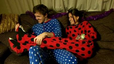 Couple wearing "onesies"