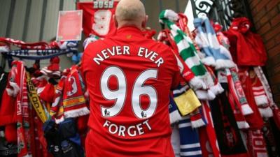 Liverpool supporter pays his respects at the Hillsborough Memorial at Anfield