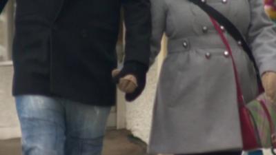 Couple holding hands