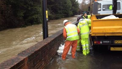 Sandbags used to plug hole in flood defence wall in Fareham