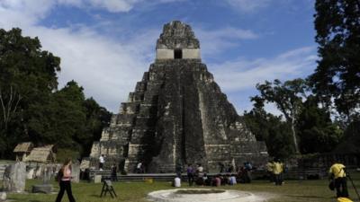 Tourists are seen in front of the "Gran Jaguar" Mayan temple at the Tikal archaeological site in Guatemala