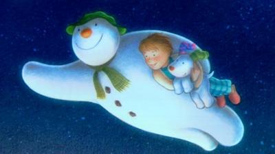 Drawing of snowman holding a boy and his dog