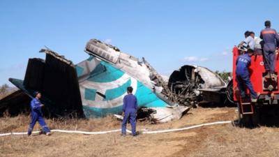 Fire Brigade team gather near the damaged Air Bagan passenger plane in Heho, Burma