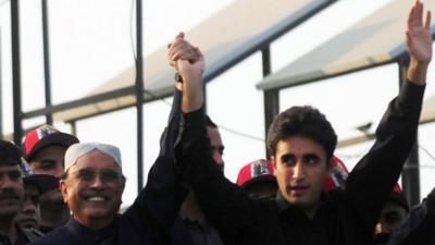 Bilawal Bhutto-Zardari (R) with his father, President Asif Ali Zardari, waving to supporters (27 Dec 2012)