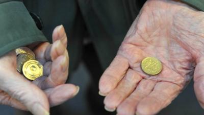 Pensioners hands holding coins