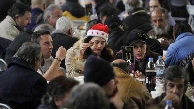 Homeless people are served a New Year's dinner offered by the municipality of Athens