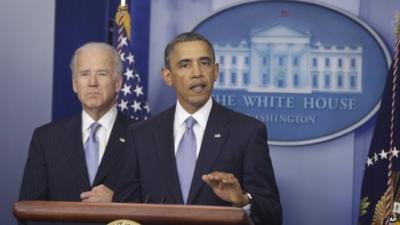 President Barack Obama, with Vice-President Joe Biden at his side, makes a statement regarding the passage of the fiscal cliff bill in the press briefing room at the White House in Washington, 1 January 2013