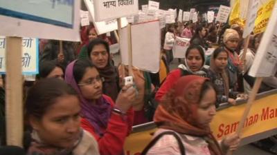 Women hold placards during protest in Delhi