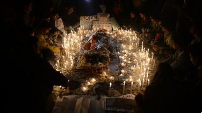 Indian protestors light candles