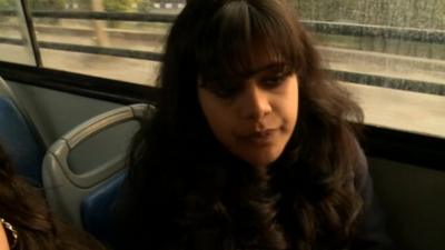 Woman on board a bus in Delhi