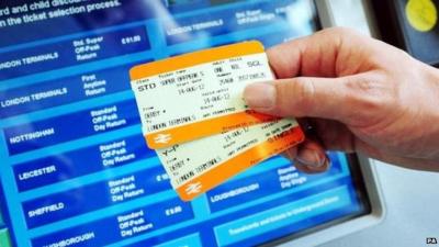 Rail tickets held out in front of ticket machine