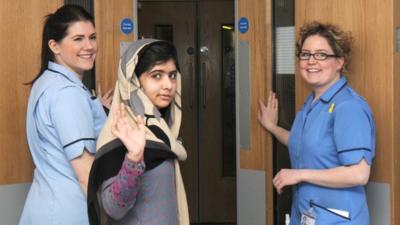 Malala accompanied by two nurses at the Queen Elizabeth Hospital in Birmingham