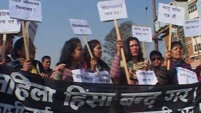 Women holding banners during a protest in Nepal