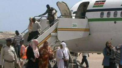 Somali refugees getting off a plane