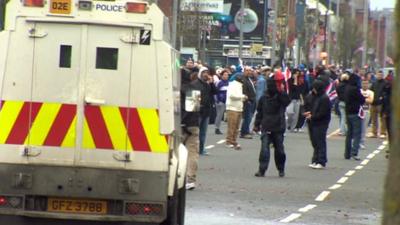 Protesters face police vehicle in Belfast