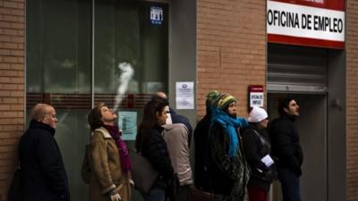 People queue to enter a government job center in Madrid, Spain.