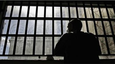 Man looking out of prison