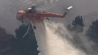 Helicopters are helping fire fighters battle the blaze