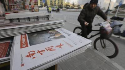 A stack of the Southern Weekly are left on display at a newsstand in Beijing