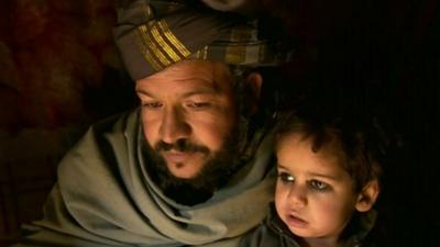 Man and child in Kabul camp