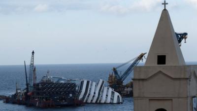 The Costa Concordia cruise ship leans on its side off the Tuscan Island Isola del Giglio, Italy