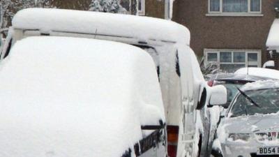 cars and van covered in snow