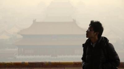 A Chinese man in front of the the Forbidden City in Beijing