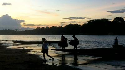 People crossing the Arauca River between Colombia and Venezuela