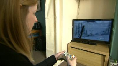 Woman playing on a games console