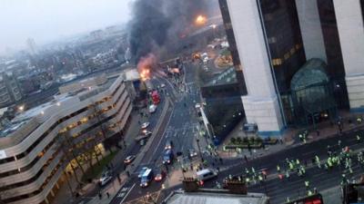 Smoke pours from the burning debris of a helicopter which crashed in London